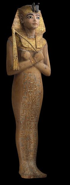 an egyptian statue is standing with his arms crossed