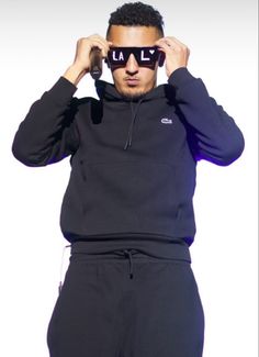 a man wearing sunglasses is holding his head