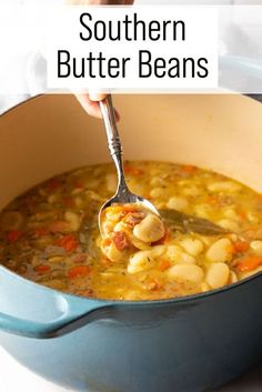 a person holding a spoon full of soup in a pot with the words southern butter beans above it