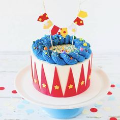 a birthday cake with blue frosting and flags on top