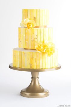 a three tiered cake with yellow flowers on top