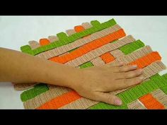 a person is holding onto some colorful placemats that are made out of burlocks