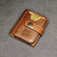 a brown leather wallet sitting on top of a table