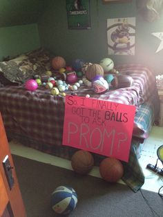 a bed with balls on it and a sign that says, so finally got the balls to as prom?