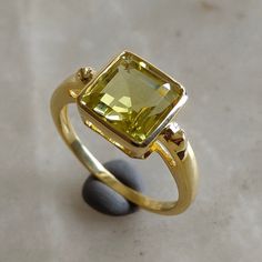 ITEM DESCRIPTION: >> The Ring is made from Solid 14K Yellow Gold. Gemstone used is absolutely natural and ethically sourced.  >> Natural Lemon Quartz in square octagon shape is studded on it with utmost precision.  >> This is a minimalist design which makes it a hassle free and everyday jewelry. Gem: Lemon Quartz Gem size: 8x8 mm square octagon Gem weight: 2.70 CT Gold purity: 14K (58.33% approx.) Gold weight: 2.01 grams  Gross weight : 2.55 grams The Gold purity is guaranteed and it comes with Modern Gold Sapphire Ring With Accent Stones, Modern Gold Emerald Ring With Accent Stones, Unique Yellow Gold Emerald Ring With Accent Stones, Elegant Yellow Sapphire Ring With Bezel Setting, Lemon Quartz Ring, Handmade Jewelry Box, Octagon Shape, Zierlicher Ring, November Birthstone