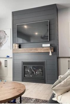 a living room with a fireplace and television on the wall