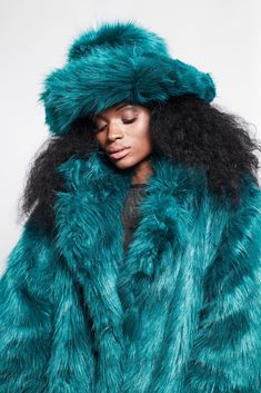 Don't be left out in the cold. Our mega floof hats are bringing warm fuzz to the head and heart. Made with synthetic faux fox fur.  56inch diameter. Fluffy Winter Hat, Blue Fur Coat, Teal Hat, Oversize Coat, Teal Fashion, Rave Fits, Green Fur, Paisley Maxi Dress, Floaty Dress