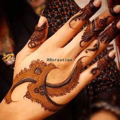 a woman's hand with hennap on it and an intricate design in the middle