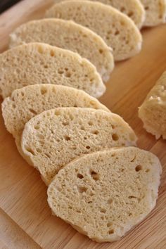 several pieces of bread sitting on top of a wooden cutting board