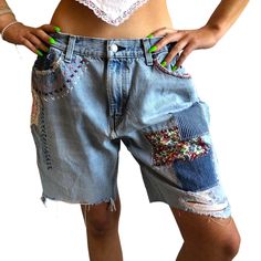 Vintage Levi's jorts with patches and embroidery.  Seen  here on a size 24/25 size S.  The perfect amount of baggy.  Waist  made smaller with added buttons.  Upcycled by Ére from all thifted materials. Measurements: Waist 15" buttoned once, 14" buttoned 2 times, not buttoned 17.25" Rise 11" inseam 9" Blue Cotton Bottoms With Patches, Casual Upcycled Bottoms For Spring, Casual Denim Bottoms With Embroidered Patch, Blue Cotton Bottoms With Collage Stitching, Short Cotton Bottoms With Patches, Vintage Bottoms With Patches For Summer, Casual Upcycled Cotton Bottoms, Cotton Bottoms With Patches In Short Length, Casual Cotton Shorts With Patches