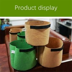 several green and brown buckets sitting on top of a wooden table with the words product display