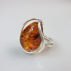 Amber ring. Sterling silver 925 genuine Amber ring. With hallmark. Brown colour available. Adjustable size Stone size 2.5 x 3 cm. Weight 9.52 gr. This item was made of natural Baltic Amber. All the amber used in my jewelry is collected in my home country Lithuania. I sell only genuine, authentic, real, natural Baltic Amber. Item may have natural imperfections. Due to amber being natural, each of my jewelry is unique and even the same models can be slightly different. Please contact me for more d Oval Baltic Amber Rings In Amber Color, Oval Baltic Amber Ring In Amber, Oval Baltic Amber Ring, Modern Amber Gemstone Ring, Classic Amber Rings For Gifts, Modern Amber Oval Ring, Minimalist Amber Ring Jewelry, Modern Amber Rings For Anniversary, Amber Sterling Silver Ring With Polished Finish