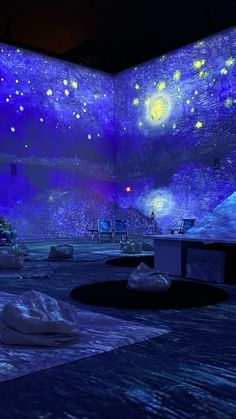 an empty room with blue lights and stars on the ceiling