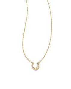 Add a dainty symbol of luck to your necklace stack with the Noble 14k Yellow Gold Horseshoe Short Pendant Necklace in Turquoise. The classic horseshoe shape is elevated with long-lasting 14k Gold and a petite white diamond stud. This necklace is a part of Yellow Rose by Kendra Scott—a brand that celebrates ranch life with Kendra Scott staples alongside select curated jewelry pieces and accessories. We have taken steps to ensure that, when applicable, our diamonds are conflict free by requiring our suppliers to comply with the Kimberley Process. Metal 14k Yellow Gold Closure Spring Ring Clasp Size 18" Chain With 2"Extender, 0.31"L X 0.32"W Diamond Quality Diamond H SIDue to the one-of-a-kind nature of the medium, exact colors and patterns may vary slightly from the image shown. | Kendra Sco Short Pendant Necklace, Gold Horse, Yellow Gold Pendants, Gold Pendant Necklace, Quality Diamonds, Yellow Rose, Huggies Earrings, Kendra Scott, Diamond Studs