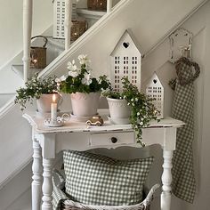 a white table topped with flowers next to a stair case