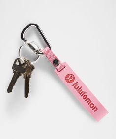 a pink keychain with two keys attached to it and the name lultenberg on it