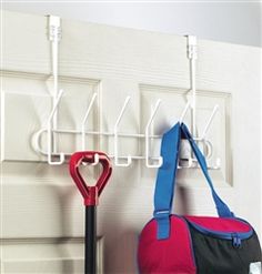 two umbrellas and a handbag hanging on a hook in front of a door