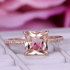 a pink diamond ring sitting on top of a white keyboard