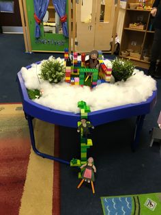 a child's play table made out of legos and snow in a classroom