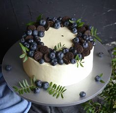 a cake with blueberries and oreo cookies on it