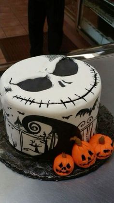 a decorated cake with pumpkins and jack - o'- lantern faces on it