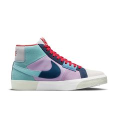 The Nike SB Skateboard Zoom Blazer Mid PRM is part of the 'Mosaic Pack,' which features a fractured aesthetic inspired by the community art spaces of Barcelona. The upper is made of a combination of turquoise leather, off-white suede, and lavender suede and textile, with chopped-up Swooshes adding to the collage-like effect. The light grey mesh on the tongue and heel tab features a Nike wordmark in multicolor embroidery. Performance benefits include a reinforced ollie zone, Zoom Air cushioning i Nike Skate Shoes, Nike Sb Zoom Blazer Mid, Nike Sb Zoom Blazer, Nike Sb Blazer, Nike Sb Zoom, Blue Tomato, Turquoise Leather, Blazer Mid, Nike Blazer