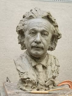 a clay busturine of an old man with curly hair