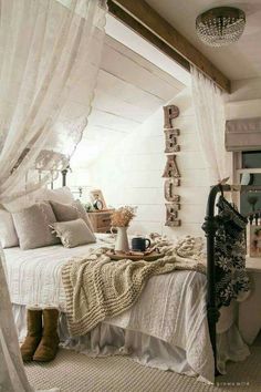 a white bed sitting under a window in a bedroom