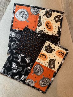 four halloween quilts laid out on the floor