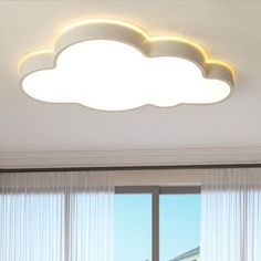 a white cloud shaped ceiling light in a living room