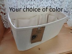 a close up of a white basket on a table with the words your choice of color