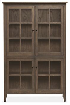 a wooden bookcase with glass doors on the front and bottom shelves in dark brown