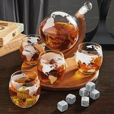 an assortment of whiskeys and ice cubes on a table with a wooden tray