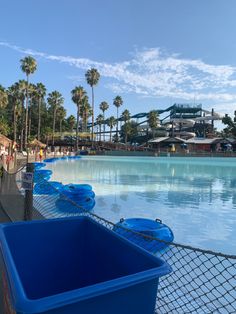 there are many blue buckets lined up along the side of the water at disney's animal kingdom