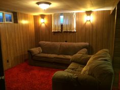 a living room with two couches and red carpet