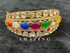 Silver Moissanite Polki Bracelet| Navratan Polki Bracelets | Indian Traditional Bracelets |Semi Precious Bracelets| Openable Kada |Bridal Jewelry Material : Silver Gemstone: Moissanite Stone colour: Uncut polki, Semi Precious Stone, Multi colour Primary colour: Gold Closure Box Lock , Openable Bracelet length: 2.4 Anna Silver Intricate, hand crafted, Pure Silver Polki Bracelet, studded with high quality Moissanite Polki , made in 92.5 silver with 22ct gold plating. Product comes with 92.5 silver Round Bracelets For Diwali Celebration, Fusion Hand Set Bracelets For Diwali, Elegant Bracelets For Diwali Celebration, Elegant Bracelet For Diwali Celebration, Multicolor Meenakari Bracelet For Ceremonial Occasions, Formal Multicolor Hand Set Bracelets, Fusion Style Hand Set Bracelets For Diwali, Fusion Style Hand-set Bracelets For Diwali, Traditional Gemstone Bracelets For Festive Season