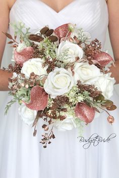 a bridal bouquet with white roses and greenery