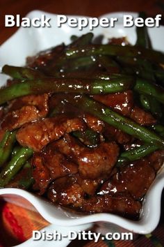 a white bowl filled with meat and green beans