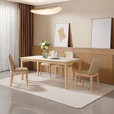 a dining room table with four chairs and a vase on the floor in front of it