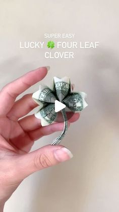 a person holding money in their hand with the text super easy lucky four leaf clover