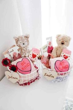 two teddy bears sitting next to each other in baskets with hearts and tags on them