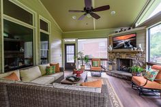 a living room with wicker furniture and a flat screen tv