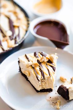 there is a piece of cake on the plate with chocolate and peanut butter toppings