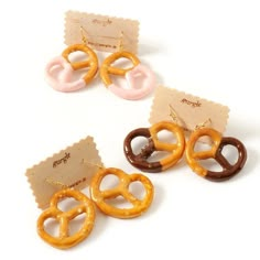 three different types of pretzels are shown on a white surface, one is brown and the other is pink