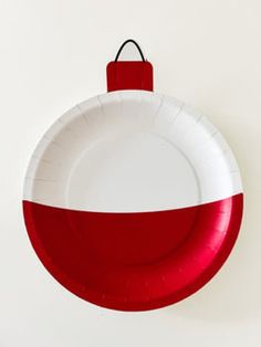 a red and white paper plate hanging on the wall