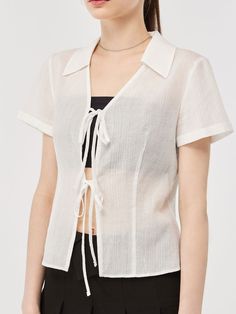 Editor's Notes This blouse is made of cotton. It features a tie detail, embroidery logo detail on the hem, collar detail, and slim waist detail which makes the blouse more feminine and lovely. Wear this item with any bottom. - Classic design short-sleeve blouse- Stylish item and a slim fit- Semi-see-through detail- Must-have item and easy to coordinate Measurements(in.)Size (S/M) - Total length: 21.06 in. / 21.45 in. - Shoulder: 14.96 in. / 15.35 in. - Chest: 17.32 in. / 18.30 in. - Waist: 14.37 in. / 15.35 in. - Hem: 17.32 in. / 18.30 in. - Sleeve length: 6.30 in. / 6.70 in. - Sleeve width: 7.28 in. / 7.48 in. - Sleeve hem: 6.70 in. / 6.88 in. *Model info: Nika Height 5'70, Bust 30 in., Waist 23 in., Hips 35 in., Wearing S, Summer Cotton Tie Neck Top, Chic Cotton Tie Neck Top, Casual Cotton Tie Neck Blouse, Casual Cotton Tie-neck Blouse, Casual Fitted Blouse With Tie Neck, Casual Fitted Tie Neck Blouse, Classic Spring Tie Neck Tops, White Tie Neck Cotton Top, Cotton Tie Neck Blouse For Daywear