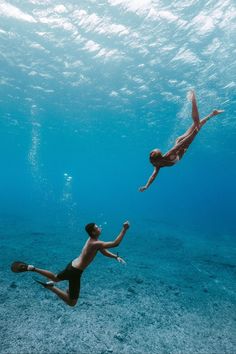 two people are swimming in the ocean together