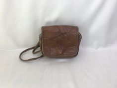 "Vintage 80's patched leather cocoa/cappuccino brown handmade purse, crossbody bag. Retro design purse boho casual rustic ladies accessories. Inside is textile lining, 1 large compartment, 1 frontal open way pocket and 1 zippered back compartment. condition: great vintage. Has small scratches on the leather surfaces around the magnetic closure (on bottom). Without seriously damages. measurements: height: 16,5 cm / 6.4\" in width: 21 cm / 8.2\" in strap length (no adjustable): 130 cm / 50.7\" in" Distressed Brown Crossbody Shoulder Bag For Travel, Vintage Brown Flap Shoulder Bag, Vintage Brown Flap Bag, Vintage Brown Crossbody Flap Bag, Vintage Brown Rectangular Flap Bag, Brown Satchel With Cell Phone Pocket, Distressed Brown Leather Shoulder Bag With Rectangular Shape, Distressed Brown Rectangular Shoulder Bag With Leather Backing, Vintage Brown Flap Bag For Travel