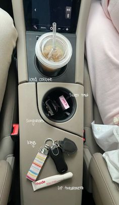 the interior of a car with keys, cups and other items attached to the door handle