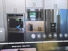 a kitchen with stainless steel appliances and white cabinets, including microwaves and refrigerators